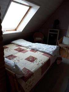 a bedroom with a bed with a quilt on it at Lodge 31 in Neue Tiefe Fehmarn