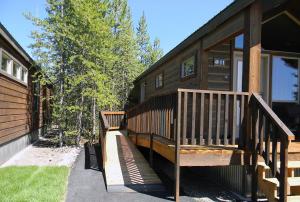 a house with a staircase leading to a porch at Explorer Cabins at Yellowstone in West Yellowstone