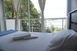 een bed met twee handdoeken bovenop bij La Manigua hostal in Buenaventura
