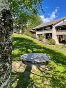 a stone bench in a yard next to a building at Val Du Rio in Le Chambon-sur-Lignon