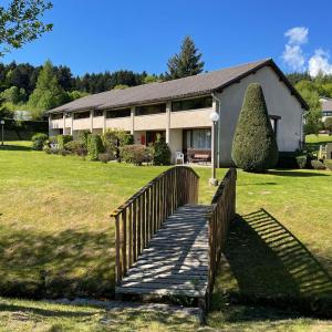 a wooden bridge in front of a house at Val Du Rio in Le Chambon-sur-Lignon
