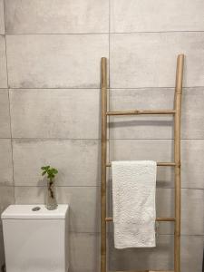 a towel rack next to a toilet in a bathroom at The Palms Apartment - Sun & Sea Madeira in Madalena do Mar +39 photos