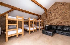 a living room with bunk beds and a couch at Muncaster Castle Coachman's Quarters in Ravenglass