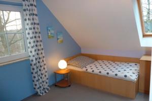 ツィングストにあるAm Deich 44の小さなベッドルーム(ベッド1台、窓付)