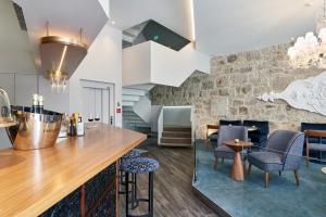a kitchen with a bar with chairs and a table at Rio da Vila in Porto