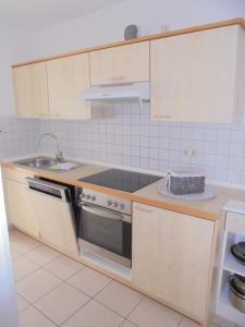 a kitchen with a sink and a stove at "Ferienhaus Vadersdorf" Wohnung 2 in Vadersdorf