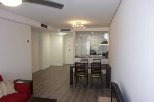 a living room and kitchen with a table and chairs at Brisa de Mar en Oliva Nova, junto a MET y golf in Oliva