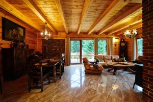 a living room with a couch and a table at BORYSÓWKA in Kopanica