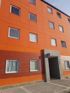 an orange building with an open door at Alto Magallanes in Ushuaia