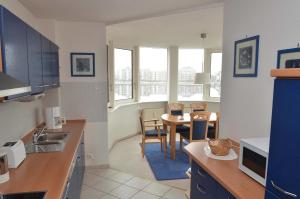 a kitchen with a table and a dining room at Apartment 113 in Wilhelmshaven