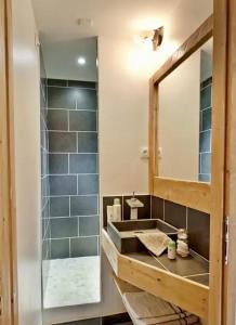 a bathroom with a sink and a mirror at Apartment ski in/out Val Thorens in Val Thorens