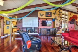 a living room with a couch and a tv at Colorful El Cajon Gem Deck, Garden and Valley Views in El Cajon
