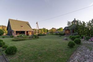 a large yard with a house and a building at Sodyba "Baltalaukis" in Didžiosios Kabiškės