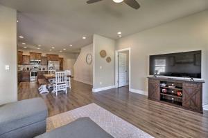 a living room with a couch and a flat screen tv at Fayetteville House Pool Access and Gas Grill! in Fayetteville
