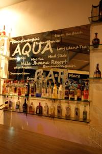 a display of bottles of alcohol on a shelf at Villa Jhoana Resort in Angono