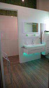 a bathroom with a sink and a mirror at LandLoft in Tauberbischofsheim