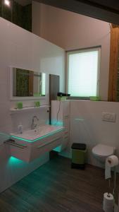 a white bathroom with a sink and a toilet at LandLoft in Tauberbischofsheim