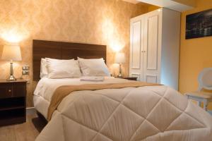 A bed or beds in a room at Hotel Paradis Suite Cusco