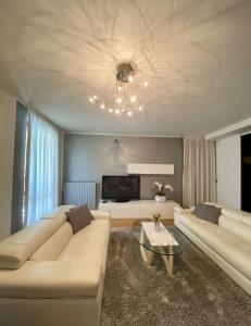 a living room with a couch and a tv at Franciacorta Suite in Corte Franca