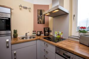 a kitchen with a sink and a stove at ancora Marina Haus 2 Nr 05, Typ 1 in Neustadt in Holstein