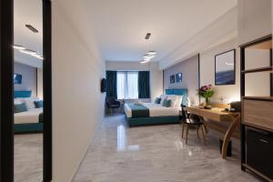 a hotel room with two beds and a desk at Trendy Hotel by Athens Prime Hotels in Athens