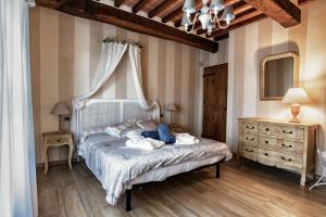 a bedroom with a white bed with a canopy at Podere Ortaglia di Sopra in Castiglion Fiorentino +43 photos