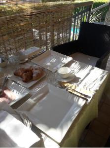 a table with plates of food on top at Franciacorta Suite in Corte Franca