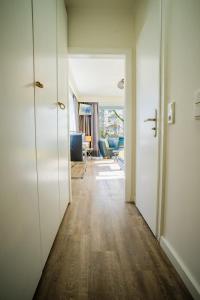 a hallway with white doors and a living room at Studio 41 "Sonnenschein" in Grömitz