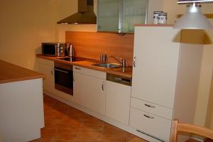 a kitchen with white cabinets and a sink at Ut Kiek 4 in Zingst