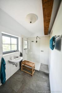 a white bathroom with a sink and a shower at Dreiurtshof in Remplin