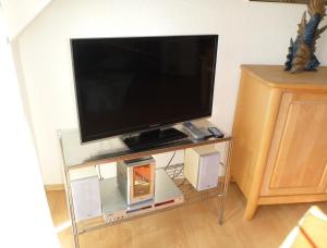 a flat screen tv sitting on a glass stand at Sunshine in Zingst