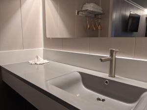 a white sink in a bathroom with a mirror at Stay Express Inn Chattanooga in Chattanooga +18 photos