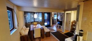 a living room with a table and chairs in a room at Sonnenchalet in Westerheim