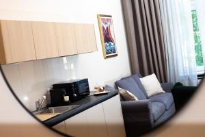 a living room with a couch and a microwave at Apartments 19 in Zagreb