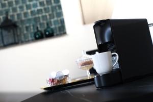 a table with a coffee mug and a laptop computer at Apartments 19 in Zagreb