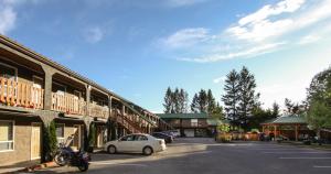 a car parked in a parking lot next to a building at Crystal Springs Lodge in Radium Hot Springs