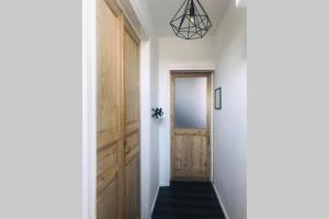 a hallway with a wooden door and a staircase at Weekend 18 in Ronse