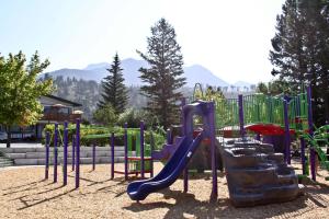 a playground with a slide in a park at Crystal Springs Lodge in Radium Hot Springs