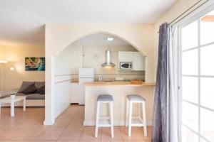 een keuken met een aanrecht en 2 barkrukken bij Carihuela Front Beach in Torremolinos