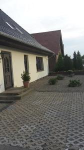 a house with a brick driveway in front of it at ferienwohnung köster in Ostseebad Karlshagen