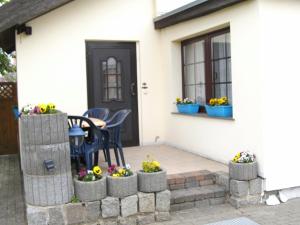 a patio with flowers in pots on a house at ferienwohnung köster in Ostseebad Karlshagen