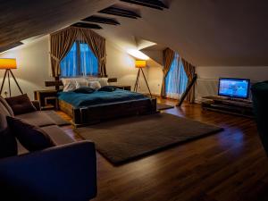 a bedroom with a bed and a flat screen tv at Casa Delia in Câmpulung Moldovenesc