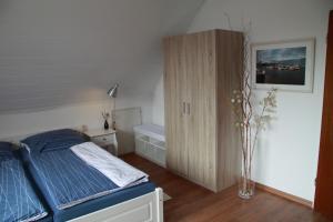 ein Schlafzimmer mit einem Bett und einem Schrank darin in der Unterkunft Ferienwohnung weißes Haus in Meeschendorf