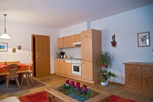 a living room with a kitchen and a dining room at Haus Savoy - Appartement 1 in Kitzbühel