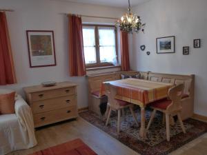 a dining room with a table and a couch at Haus Savoy - Appartement 1 in Kitzbühel