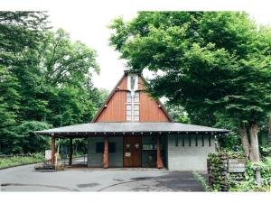 a building with a gambrel roof with a tree at HOTEL KARUIZAWA CROSS - Vacation STAY 56467v in Karuizawa +24 photos