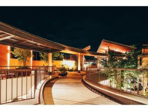 a building with a wooden walkway at night at HOTEL KARUIZAWA CROSS - Vacation STAY 56435v in Karuizawa
