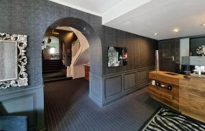 un couloir d'une maison avec une arche et un escalier dans l'établissement Hôtel Restaurant Villa Riva, à Veyrier-du-Lac