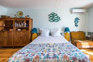 a bedroom with a bed with a colorful bedspread at Lisbon Heart Apartments - Yellow Apartment by LovelyStay in Lisbon