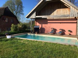 a house with a swimming pool in the yard at Hoheluft am Wittensee Apt 3 in Groß Wittensee